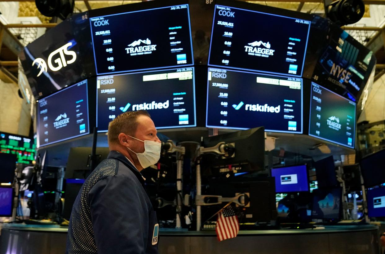 Traders work on the floor at the New York Stock Exchange in New York, on July 29, 2021. - Wall Street stocks climbed early July 29 following another round of mostly strong earnings and US data that showed strong second-quarter growth that lagged expectations. (Photo by TIMOTHY A. CLARY / AFP) (Photo by TIMOTHY A. CLARY/AFP via Getty Images)