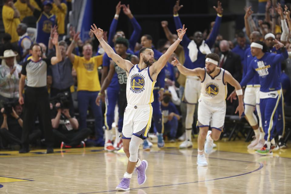 FILE - Golden State Warriors guard Stephen Curry (30) celebrates after guard Klay Thompson, right, shot a 3-point basket during the second half of Game 5 of basketball's NBA Finals against the Boston Celtics in San Francisco, June 13, 2022. (AP Photo/Jed Jacobsohn, File)