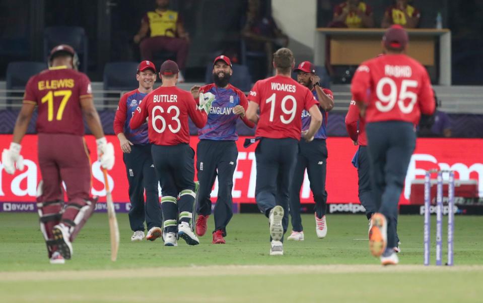 Moeen Ali is congratulated by his teammates - AP