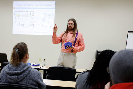 Thomas Womelsdorf, a Prevention Care Manager with the Southern Tier AIDS Program, demonstrates administering the drug Nalaxone during a free Opioid Overdose Prevention Training class provided by Lourdes Hospital in Binghamton, New York, U.S., April 5, 2018. REUTERS/Andrew Kelly