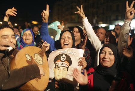 People celebrate after Egypt's army chief Field Marshal Abdel Fattah al-Sisi declared his candidacy for a presidential election, in Tahrir square in Cairo March 26, 2014. REUTERS/Asmaa Waguih