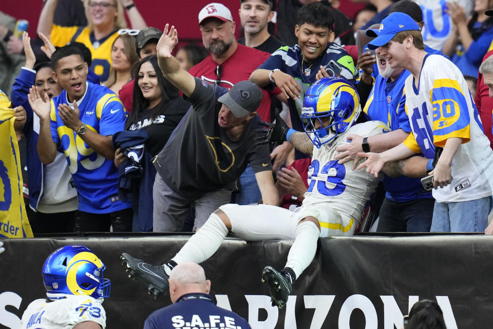 Los Angeles Rams running back Kyren Williams celebrates with fans after scoring a touchdown during the first half of an NFL football game against the Arizona Cardinals, Sunday, Nov. 26, 2023, in Glendale, Ariz. (AP Photo/Ross D. Franklin)