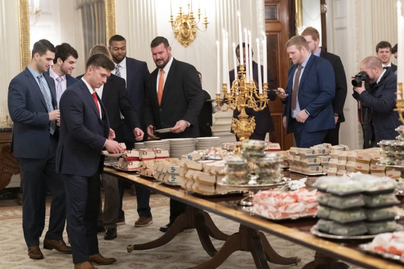 Members of the 2018 Clemson Tigers football team prepare to dine on fast food served by President Donald Trump to celebrate their championship at the White House in Washington, D.C., on Jan. 14, 2019. File Photo by Chris Kleponis/UPI