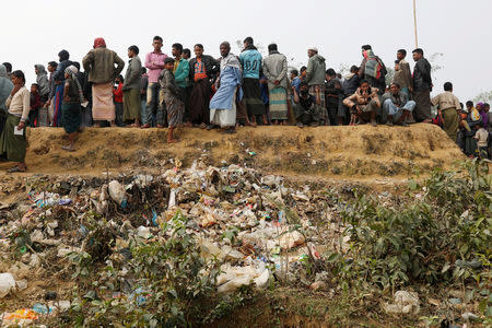 FILE PHOTO: Rohingya refugees line up for daily essentials distribution at Balukhali camp, near Cox's Bazar, Bangladesh January 15, 2018. REUTERS/Tyrone Siu/File Photo