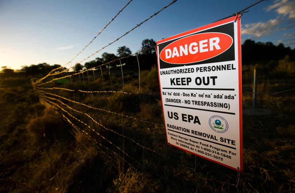 Signs posted by the Environmental Protection Agency are seen by abandoned uranium mines at Church Rock, N.M., on the Navajo Nation on May 21, 2014. There are 521 abandoned uranium mines on the Navajo Nation.