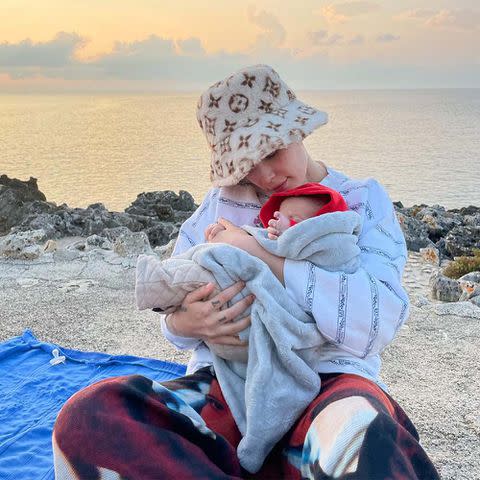 <p><a href="https://www.instagram.com/p/CVgLIuBPfjh/" data-component="link" data-source="inlineLink" data-type="externalLink" data-ordinal="1">Halsey</a></p> Halsey holding baby Ender on the beach