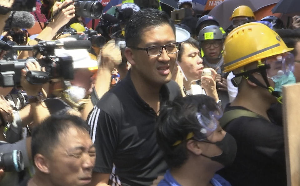 In this image made from video taken July 1, 2019, pro-democracy lawmaker Lam Cheuk-ting, who tried to stop Hong Kong protesters from breaking into the legislature, stands with protesters in Hong Kong. Lam says China will likely use the vandalizing of the building as a reason to step up pressure on the semi-autonomous Chinese territory. (AP Photo/Johnson Lai)