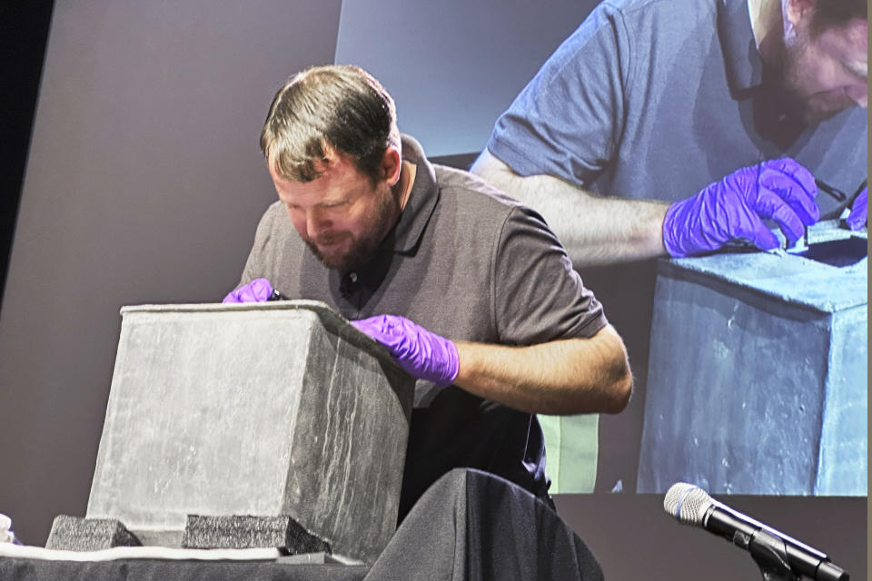 Paul Hudson, West Point archeologist, takes part in the opening of a lead box believed to have been placed in the base of a monument by cadets almost two centuries ago, at the U.S. Military Academy, Monday, Aug. 28, 2023, in West Point, N.Y. The box contained silt. (AP Photo/Michael Hill)