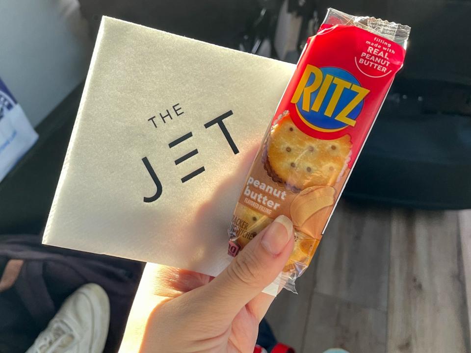 A napkin that reads "the jet" and peanut butter Ritz crackers.