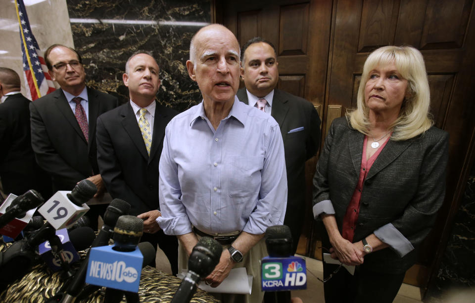 FILE -- In this Sept. 9, 2013 file photo, Gov. Jerry Brown, center, accompanied by Senate Minority Leader Bob Huff, R-Diamond Bar, left, Senate President Pro Tem Darrell Steinberg, D-Sacramento, second from left, Assembly Speaker John Perez, D-Los Angeles, second from right and Assembly Minority Leader Connie Conway, R-Tulare, talks with reporters outside his Capitol office in Sacramento, Calif. Brown enters the final year of his third term as governor with a 58 precent approval rating and has given every indication short of an official announcement that he will seek re-election this year.(AP Photo/Rich Pedroncelli, file)