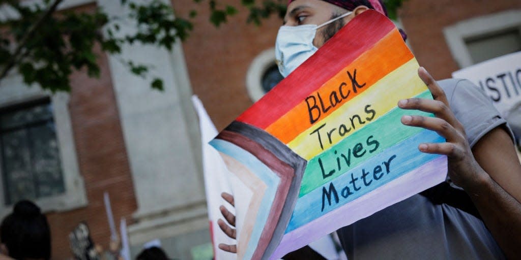 A demonstrator holds up a "Black trans lives matter" sign at a protest in Madrid, Spain, on June 7, 2020.