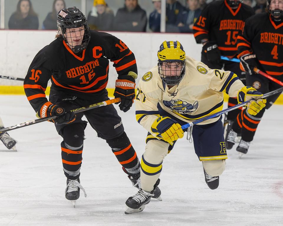 Hartland's Michael Zielinski and Brighton's Cam Duffany chase a loose puck Saturday, Dec. 16, 2023.