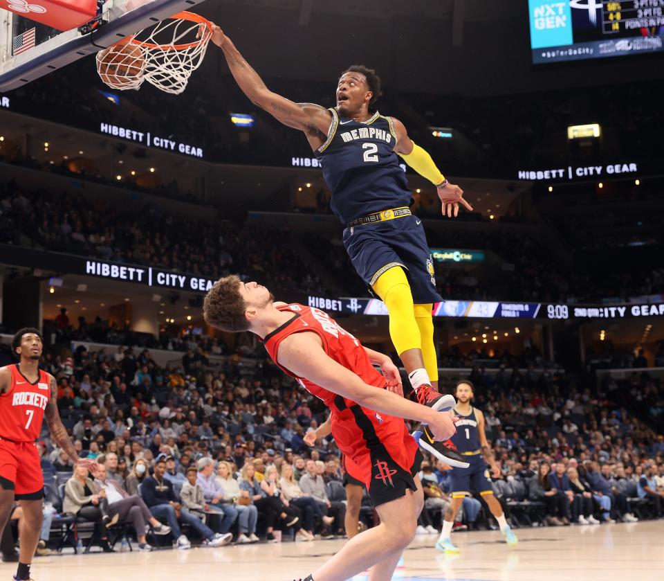 Memphis Grizzlies center Xavier Tillman dunks the ball over Houston Rockets center Alperen Sengun at FedExForum on Saturday, December 11, 2021. 