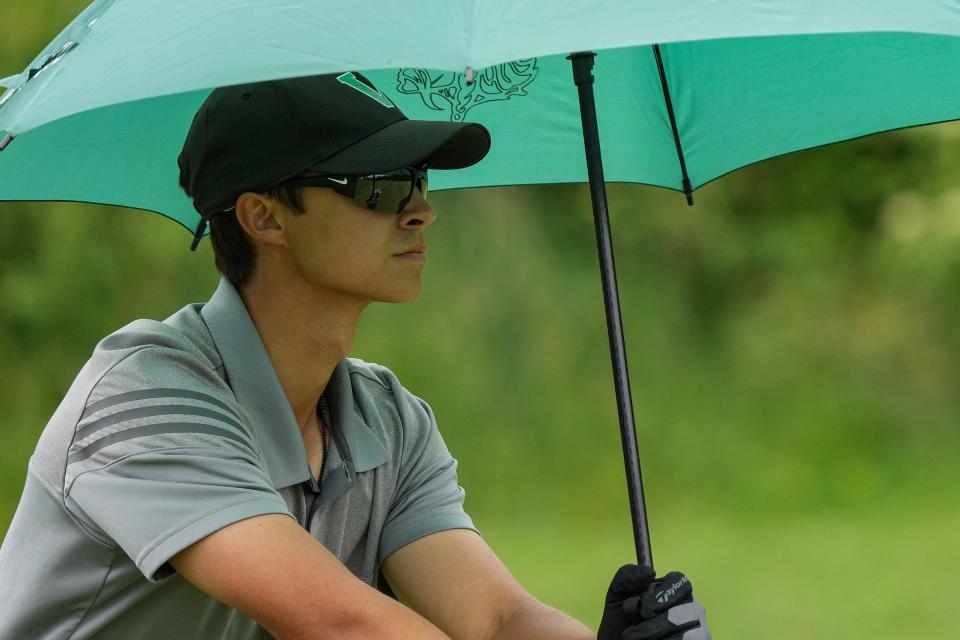 Valparaiso's Aidan Gutierrez pushes his clubs along the course at hole 10 on the first day of IHSAA boys golf state finals Tuesday, June 13, 2023, at Prairie View Golf Club in Carmel. 