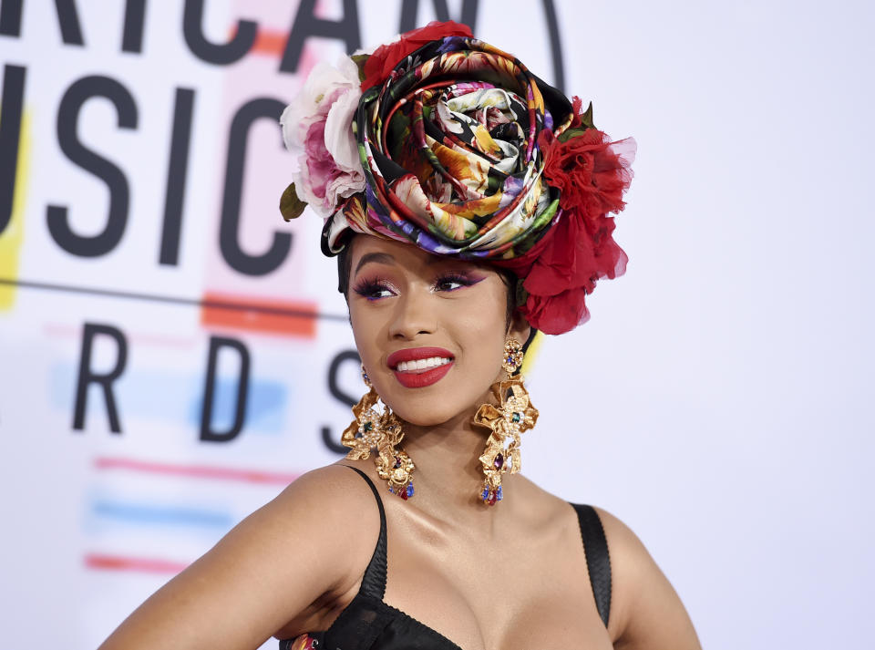 FILE - In this Oct. 9, 2018, file photo, Cardi B arrives at the American Music Awards, at the Microsoft Theater in Los Angeles. Cardi B, Pharrell, Kanye West were among the celebrities who fanned out across Miami for a week of glamorous parties toasting the world’s best artists during Art Basel. The prestigious extension of the annual contemporary art fair in Basel, Switzerland, officially opened Thursday, Dec. 6.(Photo by Jordan Strauss/Invision/AP, File)