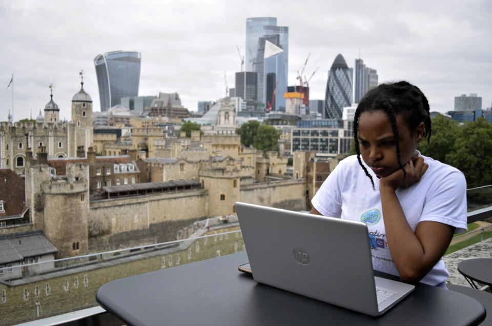 Rebekah Ingram, an intern at Like Minded Females Network, works on her laptop at WeWork, a co-operative work space in London, Thursday, Sep. 2, 2021. Many young workers around the world have entered the workforce and begun their careers during the pandemic working entirely remotely. Like Minded Females Network is a social enterprise that helps young women set up businesses and other ventures, without the use of a fixed office space. (AP Photo/Urooba Jamal)
