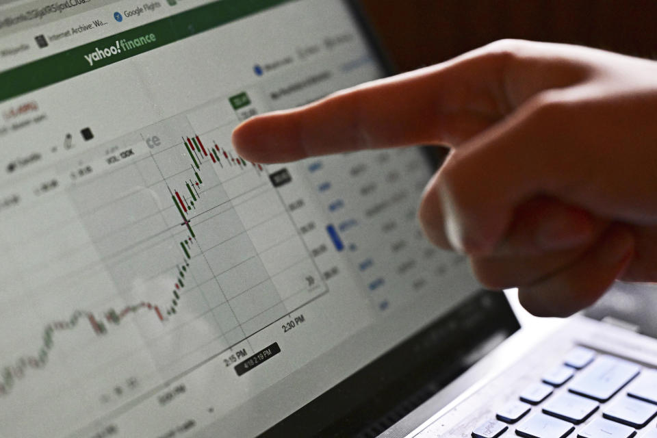 Manny Marotta points to his laptop while examining the stock chart for Trump Media and Technology Group, Wednesday, April 24, 2024, in Cleveland. Amateur traders, mostly risking no more than a few thousand dollars each, say the stock is too volatile to declare victory yet. (AP Photo/David Dermer)