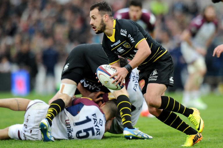 La Rochelle's scrum-half Julien Audy (R) runs with the ball during their French Top 14 rugby union match against Bordeaux-Begles, at the Chaban-Delmas stadium in Bordeaux, south-western France, on March 28, 2015