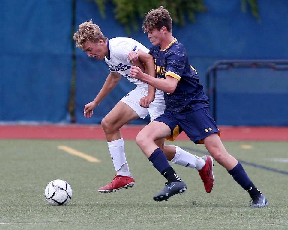 Hanover's Ben Elliott battles Norwell's William Morse for possession in the midfield during first half action of their non-league clash at Hanover High on Wednesday, Sept. 7, 2022.