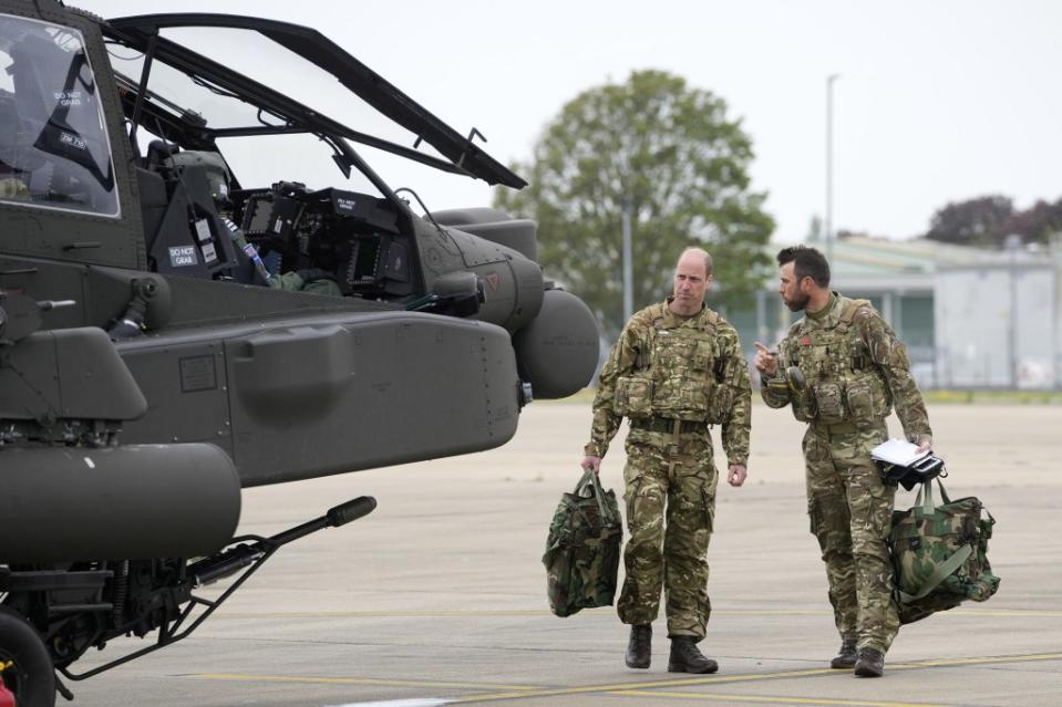 The Prince of Wales in his new role as Colonel-in-Chief of the Army Air Corps, prepares to board an Apache attack helicopter. ZUMAPRESS.com