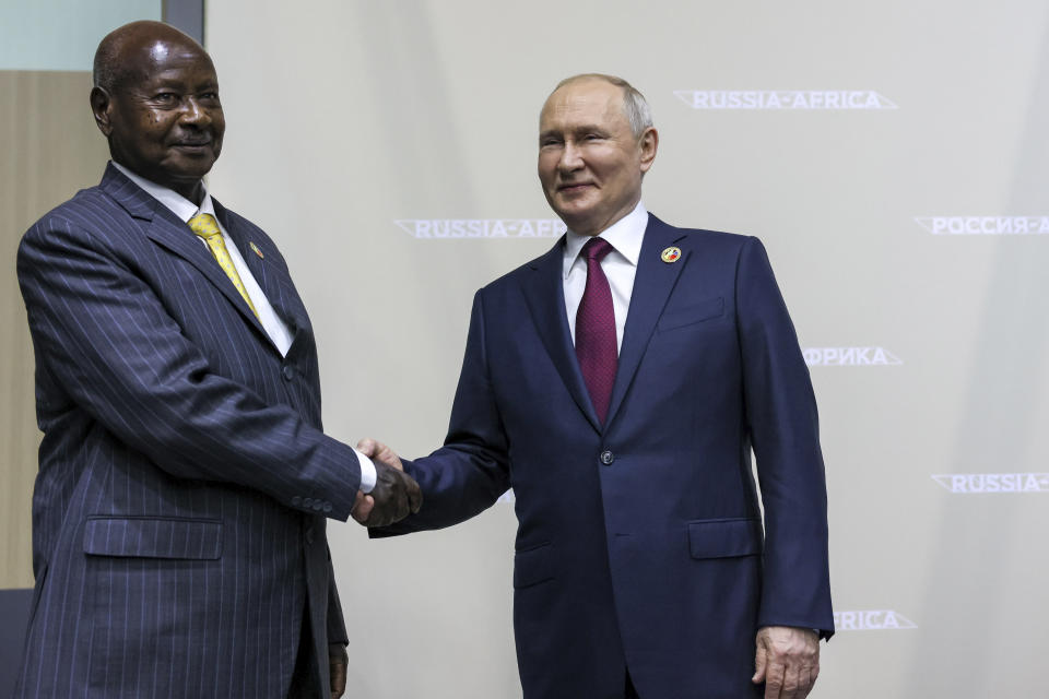 Russian President Vladimir Putin, right, and President of the Republic of Uganda Yoweri Kaguta Museveni shake hands on the sideline of the Russia Africa Summit in St. Petersburg, Russia, Thursday, July 27, 2023. (Mikhail Metzel/TASS Host Photo Agency Pool Photo via AP)