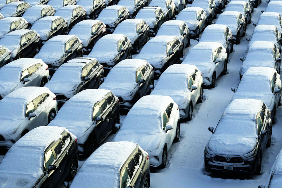 Snow covered vehicles sit in a rental car parking lot at the O'Hare International Airport in Chicago, Sunday, Jan. 14, 2024. Wind chill warning is in effect as dangerous cold conditions continue in the Chicago area. (AP Photo/Nam Y. Huh)