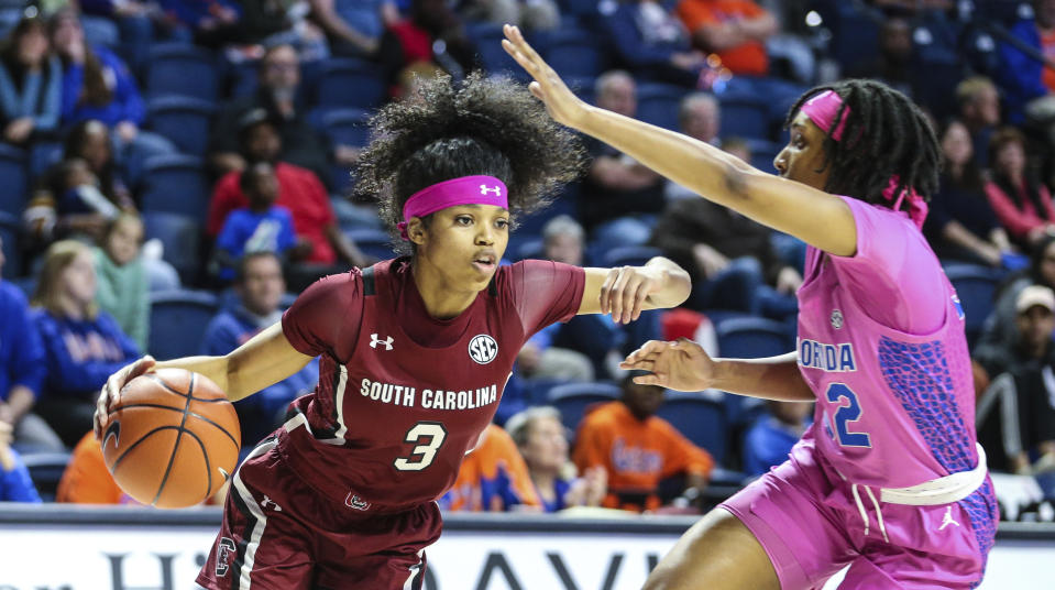 South Carolina guard Destanni Henderson (3) drives toward the basket while defended by Florida guard Ariel Johnson (32) during the first half of an NCAA college basketball game Thursday, Feb. 27, 2020, in Gainesville, Fla. (AP Photo/Gary McCullough)