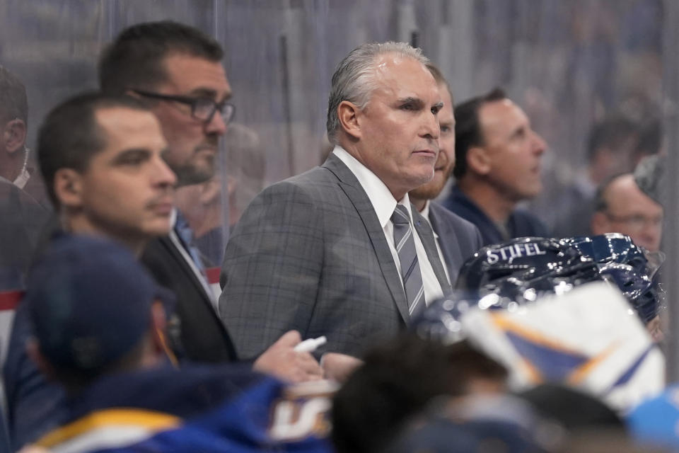 St. Louis Blues coach Craig Berube is seen on the bench during the third period of an NHL hockey game between the St. Louis Blues and the Los Angeles Kings Monday, Oct. 25, 2021, in St. Louis. (AP Photo/Jeff Roberson)