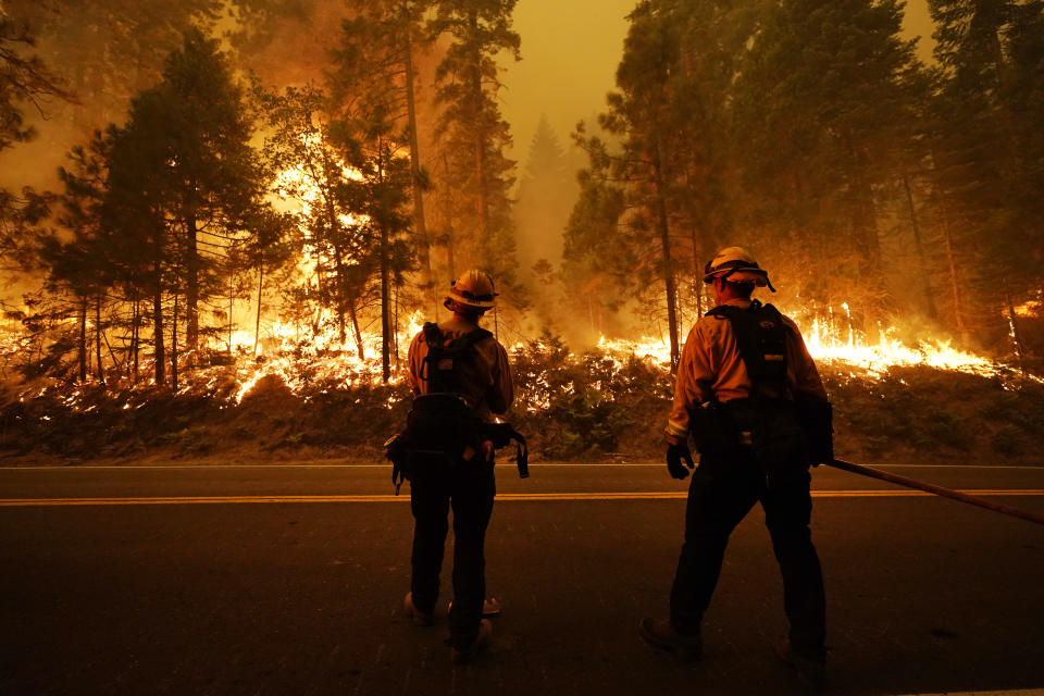 Firefighters keep an eye on the Creek Fire along state Highway 168, Sunday, Sept. 6, 2020, in Shaver Lake, Calif. (AP Photo/Marcio Jose Sanchez)