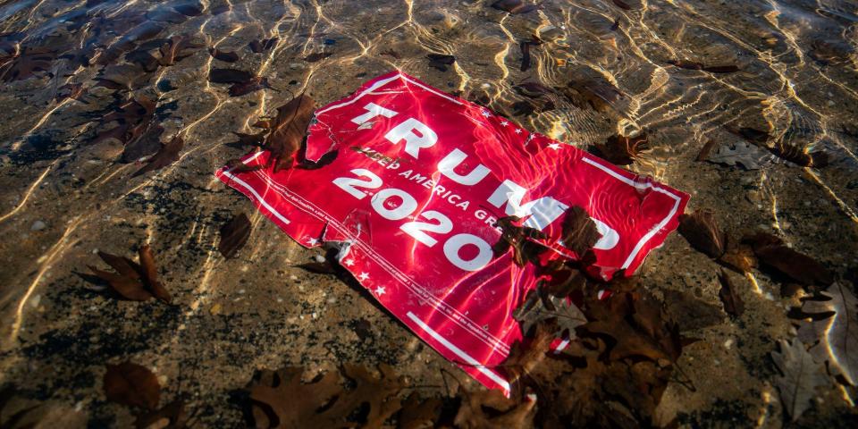 WASHINGTON, DC - JANUARY 09: A campaign sign for U.S. President Donald Trump lies beneath water in the Capitol Reflecting Pool, near the West Front of the U.S. Capitol on January 9, 2021 in Washington, DC. A pro-Trump mob stormed and desecrated the U.S. Capitol on January 6 as Congress held a joint session to ratify President-elect Joe Biden's 306-232 Electoral College win over President Donald Trump. (Photo by Al Drago/Getty Images)