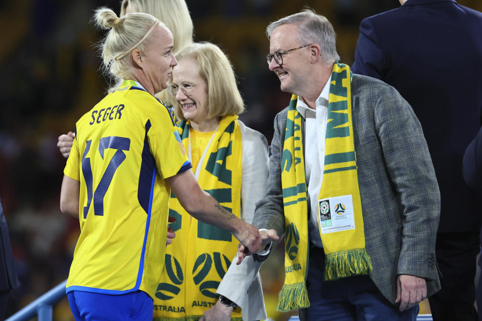 Australian Prime Minister Anthony Albanese, right, shakes hands within Sweden's Caroline Seger as they receive their bronze medals after defeating Australia in the Women's World Cup third place playoff soccer match in Brisbane, Australia, Saturday, Aug. 19, 2023. (AP Photo/Tertius Pickard)
