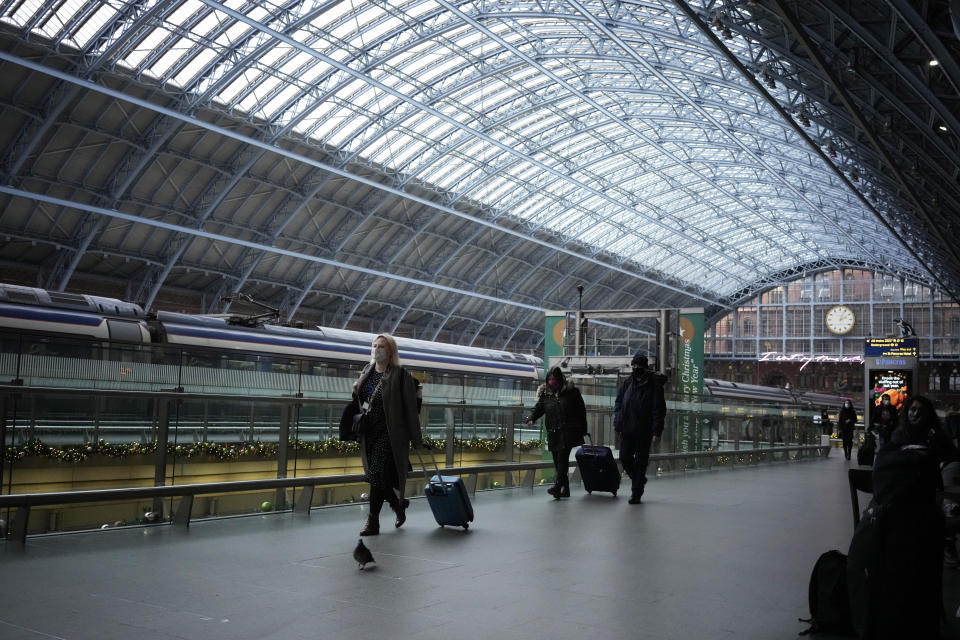 People walk through St Pancras train station, in London, Friday, Dec. 17, 2021. After the U.K. recorded its highest number of confirmed new COVID-19 infections since the pandemic began, France announced Thursday that it would tighten entry rules for those coming from Britain. Hours later, the country set another record, with a further 88,376 confirmed COVID-19 cases reported Thursday, almost 10,000 more than the day before. (AP Photo/Matt Dunham)