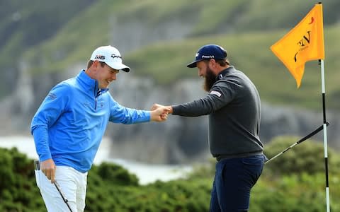 Andrew Johnston of England high fives Robert MacIntyre of Scotland on the 5th green during the first round of the 148th Open Championship held on the Dunluce Links at Royal Portrush Golf Club on July 18, 2019 in Portrush, United Kingdom - Credit: Getty Images