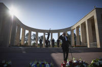 Charles Norman Shay, D-Day WWII veteran and Penobscot Elder from Maine, salutes after laying a wreath during a D-Day 76th anniversary ceremony at the Normandy American Cemetery in Colleville-sur-Mer, Normandy, France, Saturday, June 6, 2020. Due to coronavirus measures many ceremonies and memorials have been cancelled in the region with the exception of very small gatherings. (AP Photo/Virginia Mayo)