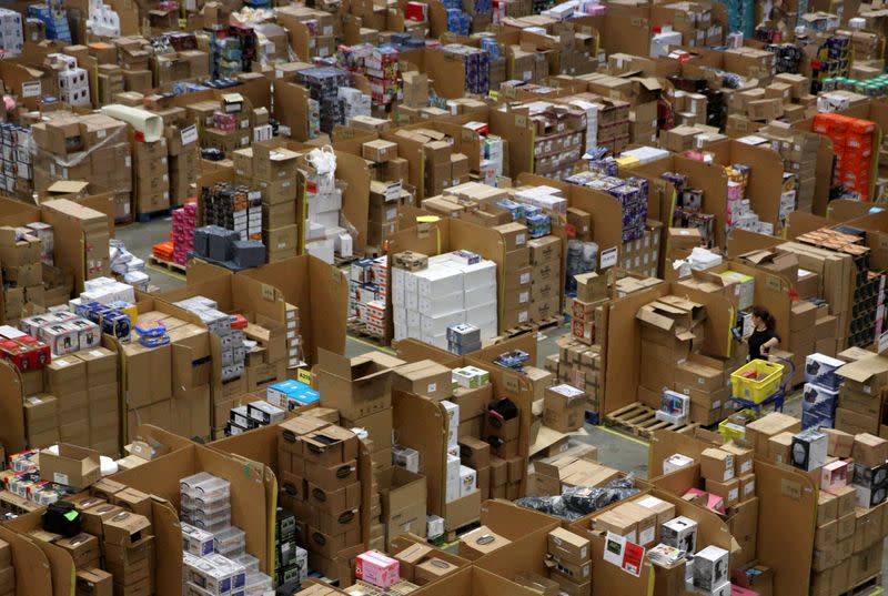 FILE PHOTO: Workers collect customer orders during Black Friday deals week at an Amazon fulfilment centre in Hemel Hempstead