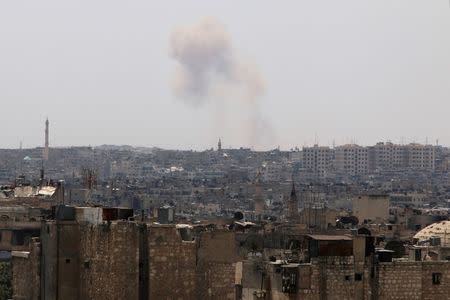 Smoke rises from Ramousah as seen from a rebel-held area of Aleppo, Syria, August 22, 2016. REUTERS/Abdalrhman Ismail