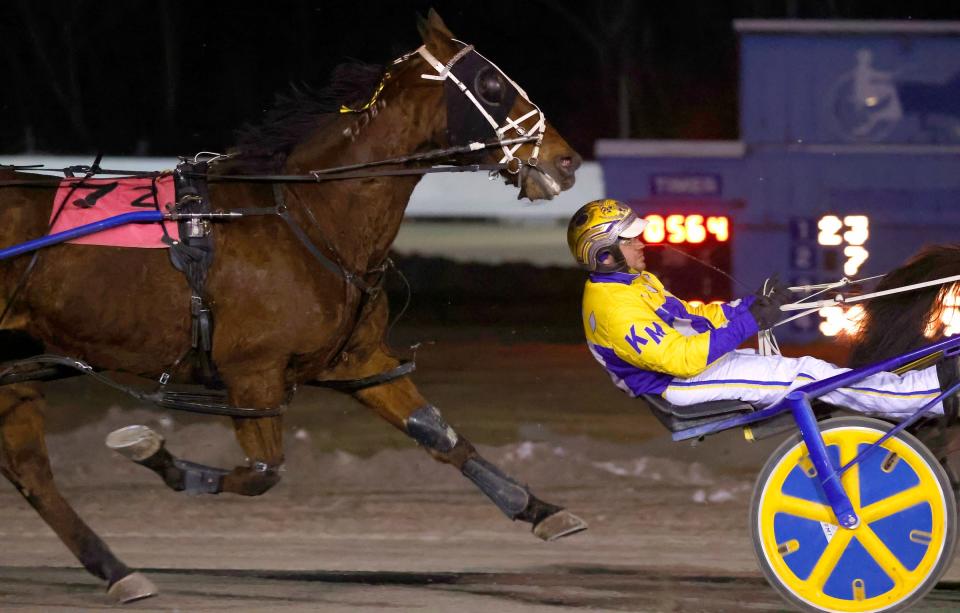 Harness racing driver Kody Massy tries to stay ahead of a charing horse and its driver during the last night of harness racing at Northville Downs on Saturday, Feb. 3, 2024.