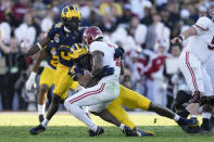 Alabama quarterback Jalen Milroe (4) is sacked by Michigan defensive end Derrick Moore (8) during the first half in the Rose Bowl CFP NCAA semifinal college football game Monday, Jan. 1, 2024, in Pasadena, Calif. (AP Photo/Mark J. Terrill)