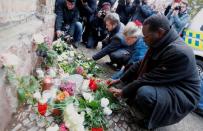 People lay flowers outside the synagogue in Halle