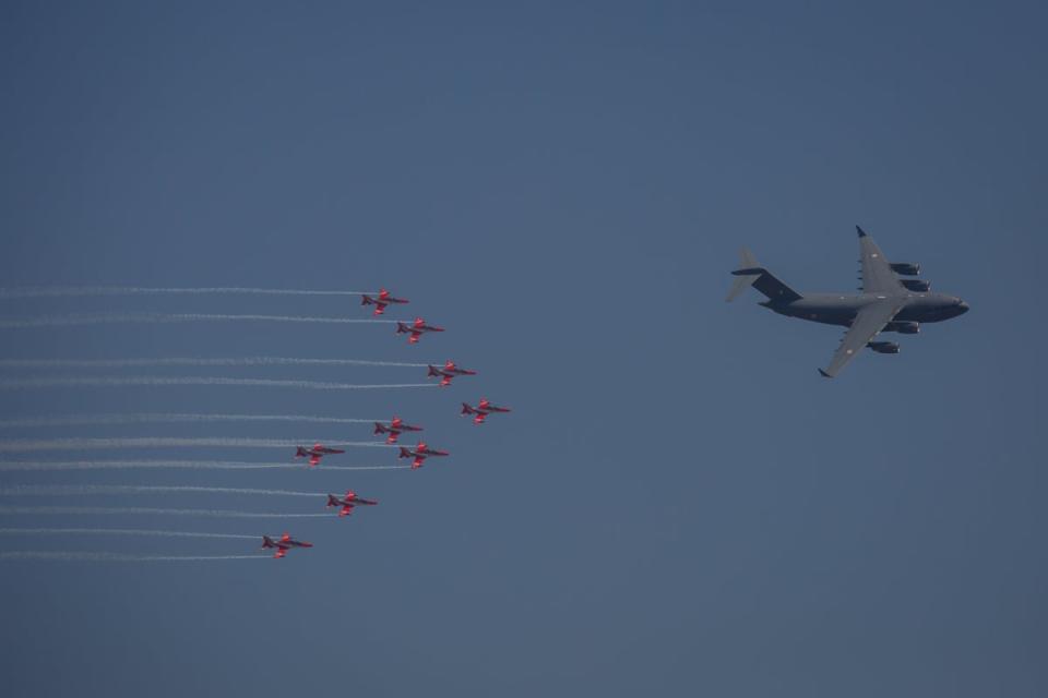 The Surya Kiran Aerobatic Team (SKAT) follows an Indian Air Force C-17-Globemaster as they perform during the inauguration of the Aero India 2023 at the Yelahanka Air Force Station in Bengaluru (Getty Images)