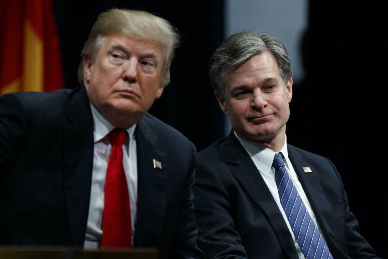 Donald Trump sits with FBI Director Christopher Wray during the Bureau's National Academy graduation ceremony on Friday: AP