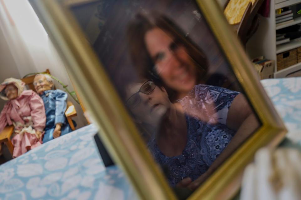 Vicky Cupp, 67, of Tecumseh, Mich., sits at her dining room table going over all the documents she has collected over the years related to the murder of her daughter Kyle Smith, who was shot outside of a nightclub on Woodward Avenue the night before Super Bowl XL in Detroit. Cupp says the police told her family that it was a “delayed arrest” situation, but 18 years later the family still does not know what happened to Kyle, who was 24 at the time of her death.