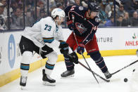 San Jose Sharks' Noah Gregor, left, and Columbus Blue Jackets' Vladislav Gavrikov chase the puck during the third period of an NHL hockey game Sunday, Dec. 5, 2021, in Columbus, Ohio. (AP Photo/Jay LaPrete)