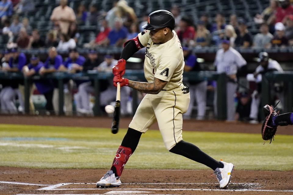Arizona Diamondbacks' Ketel Marte connects for a run-scoring double against the Colorado Rockies during the first inning of a baseball game Friday, Aug. 5, 2022, in Phoenix. (AP Photo/Ross D. Franklin)