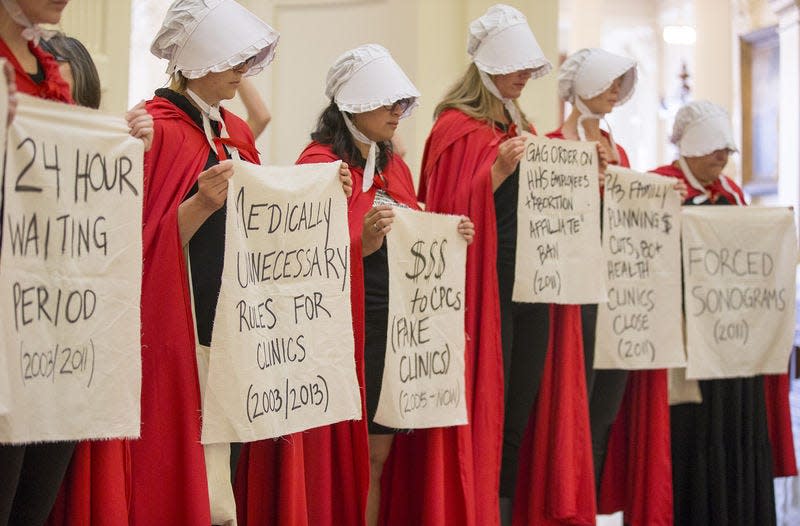 Abortion rights activists dressed as characters from "The Handmaid's Tale" protest the anti-abortion bills in the rotunda of the Texas State Capitol in Austin, Texas, in May. AP File Photo/Austin American-Statesman, RICARDO B. BRAZZIELL