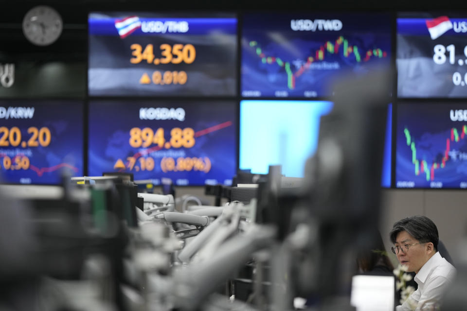 A currency trader watches computer monitors at a foreign exchange dealing room in Seoul, South Korea, Tuesday, April 11, 2023. Stocks were mostly higher in Asia on Tuesday after a mixed session on Wall Street dominated by speculation the Federal Reserve may tap the brakes again on financial markets and the economy by raising interest rates. (AP Photo/Lee Jin-man)