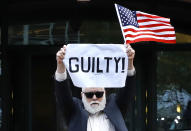 <p>Protester Bill Christeson holds up a sign saying “guilty” as the first count of guilty comes in at he trial of former Donald Trump campaign chairman Paul Manafort, at federal court in Alexandria, Va., Tuesday, Aug. 21, 2018. (Photo: Jacquelyn Martin/AP) </p>