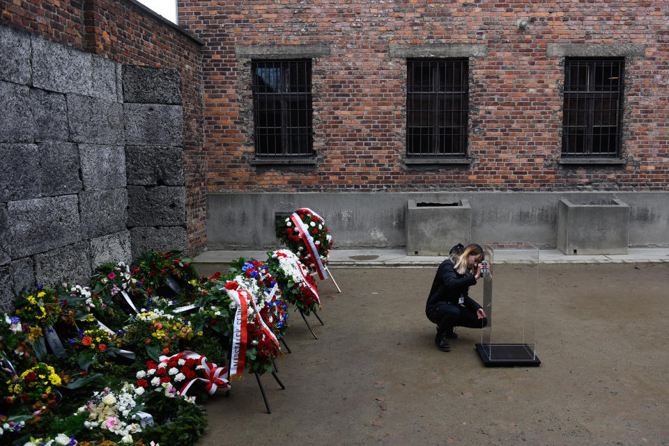 A girl kneels at a plastic structure in front of the Wall of Death.