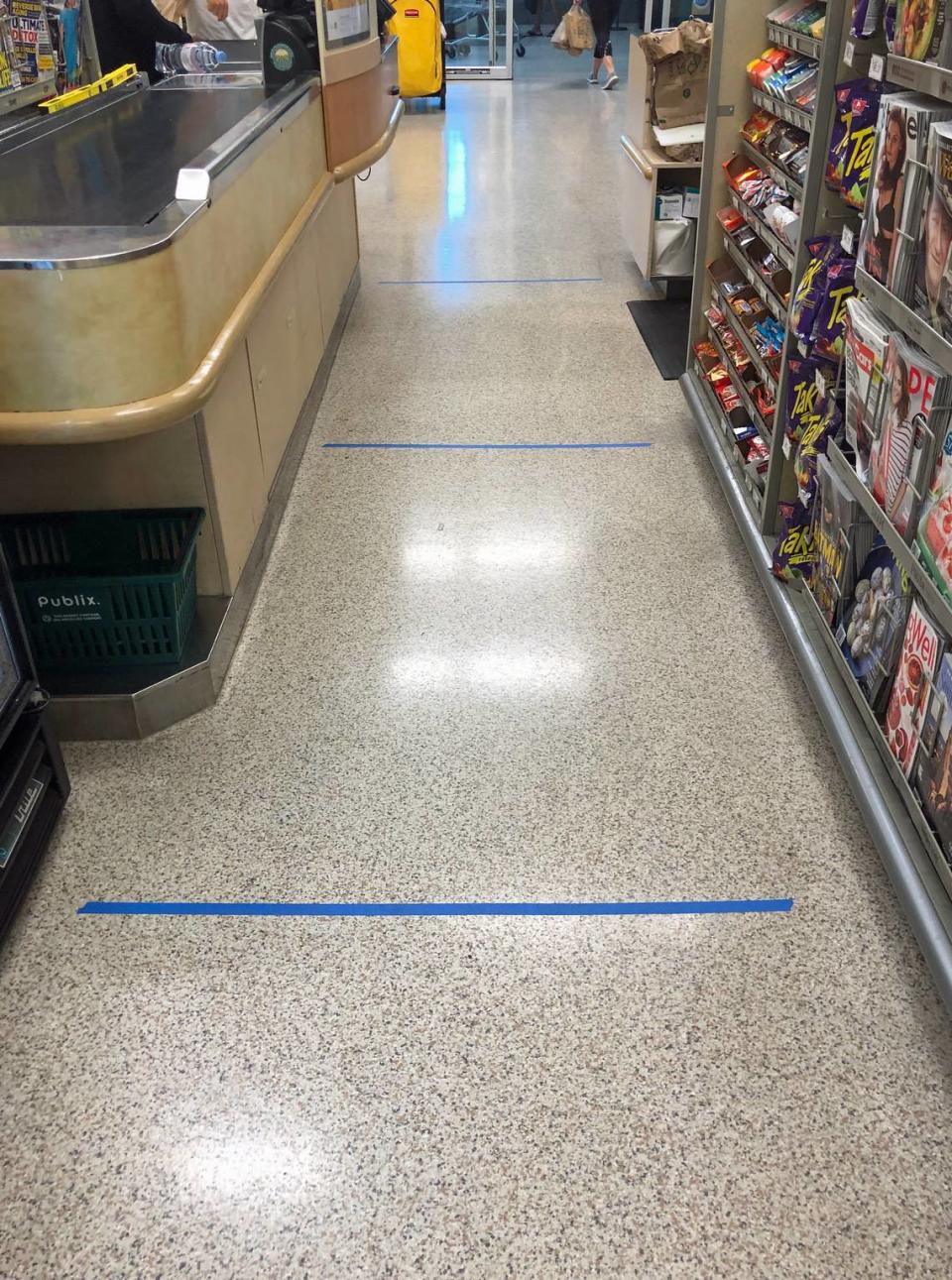 Blue tape on the floor shows shoppers how far each person should be from the next.
