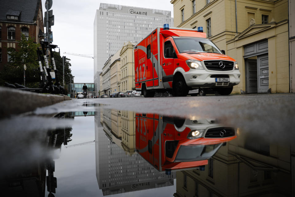 FILE-In this Sept.2, 2020 file photo a rescue vehicle drives in front of the central building of the Charite hospital where the Russian opposition leader Alexei Navalny is being treated, in Berlin, Germany. The German hospital treating Russian opposition leader Alexei Navalny says he has been taking out of an induced coma and is responsive. Berlin's Charite hospital said Monday that Navalny's condition has further improved, allowing doctors to end the medically induced coma and gradually ease him off mechanical ventilation. (AP Photo/Markus Schreiber)